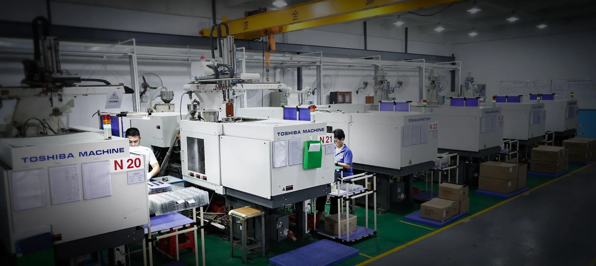Row of injection molding machines in production