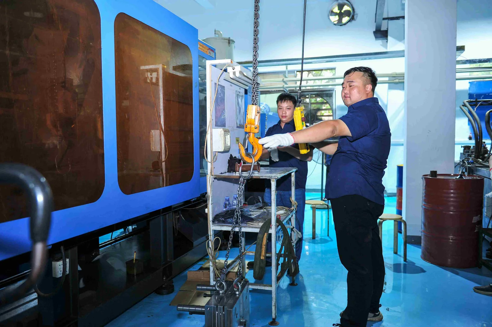 Technician setting up an injection molding machine