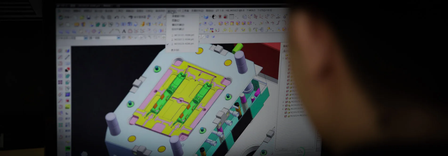 Engineer reviewing mold DFM analysis on a computer