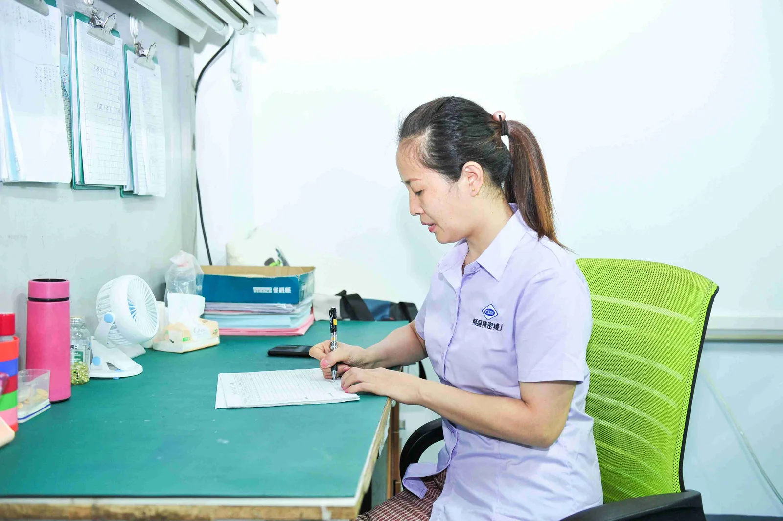 Worker manually assembling plastic parts